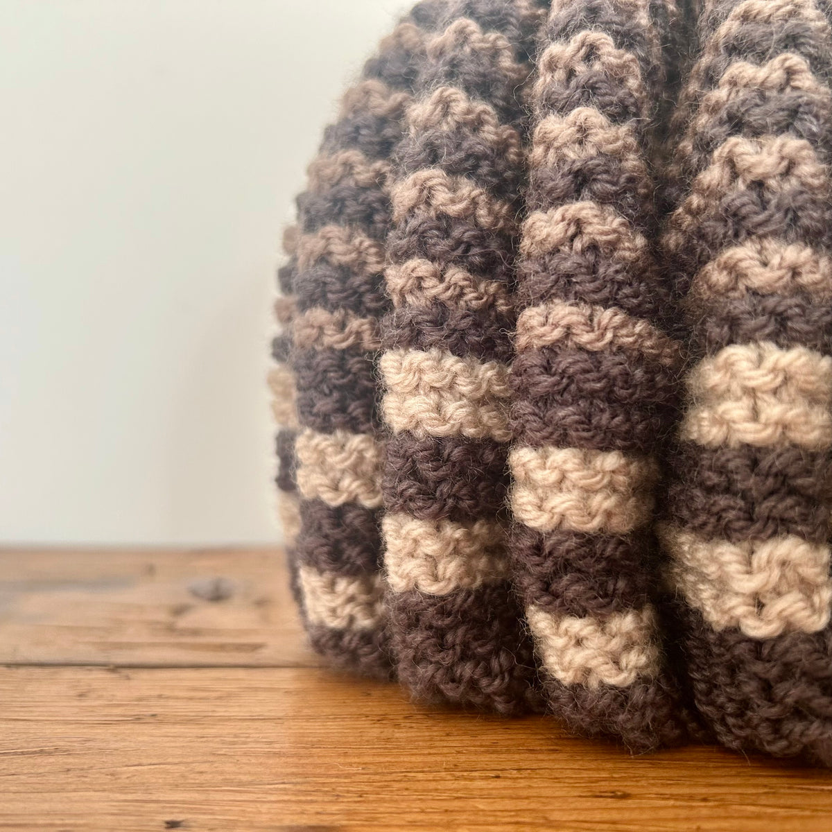 A close up of a hand kntted tea cosy